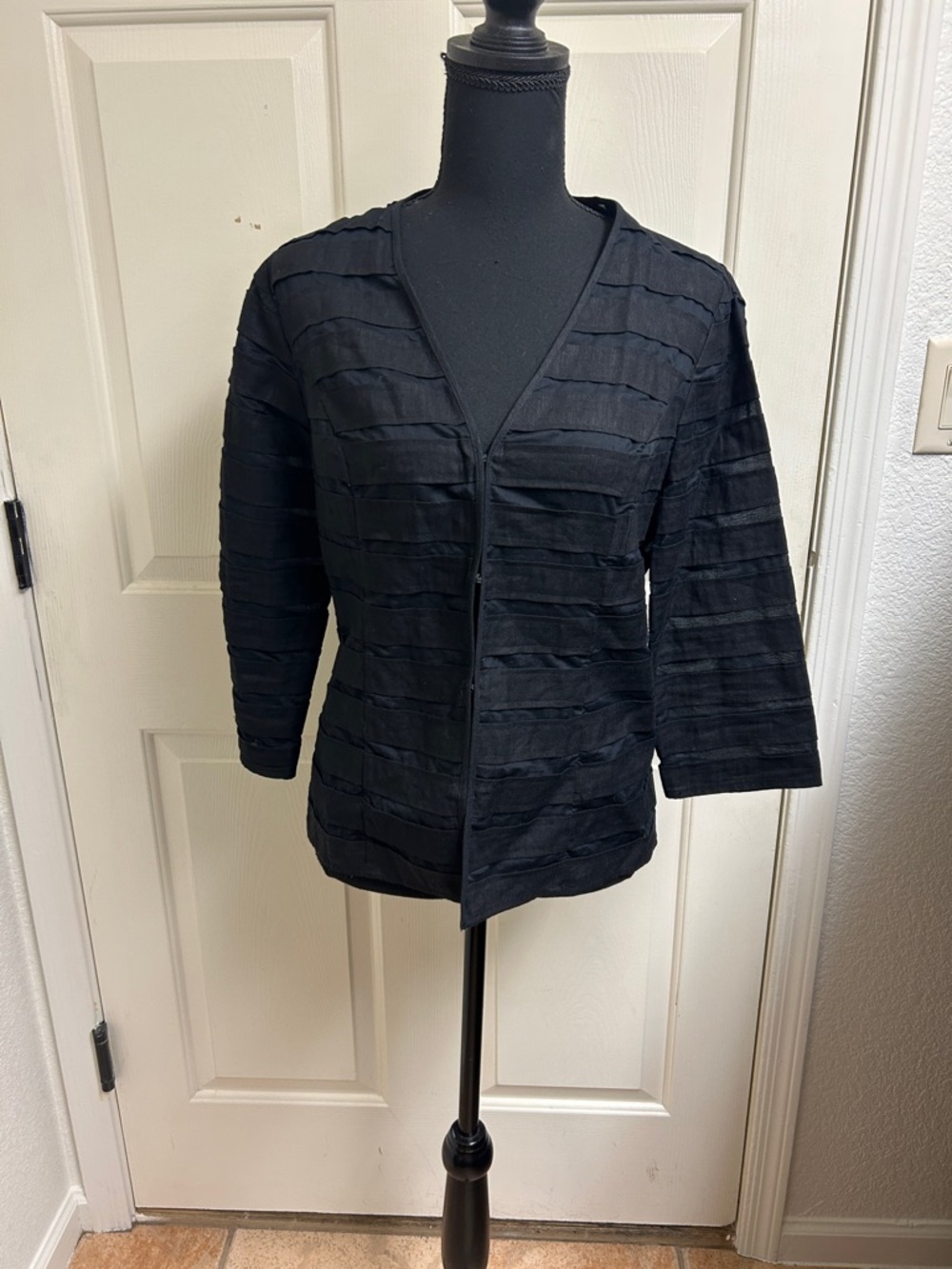Chico's black jacket featuring striped textured fabric with sheer panels, Size 0